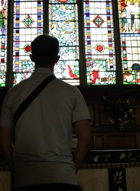 BYU Ballroom student standing in front of a stained glass window in England
